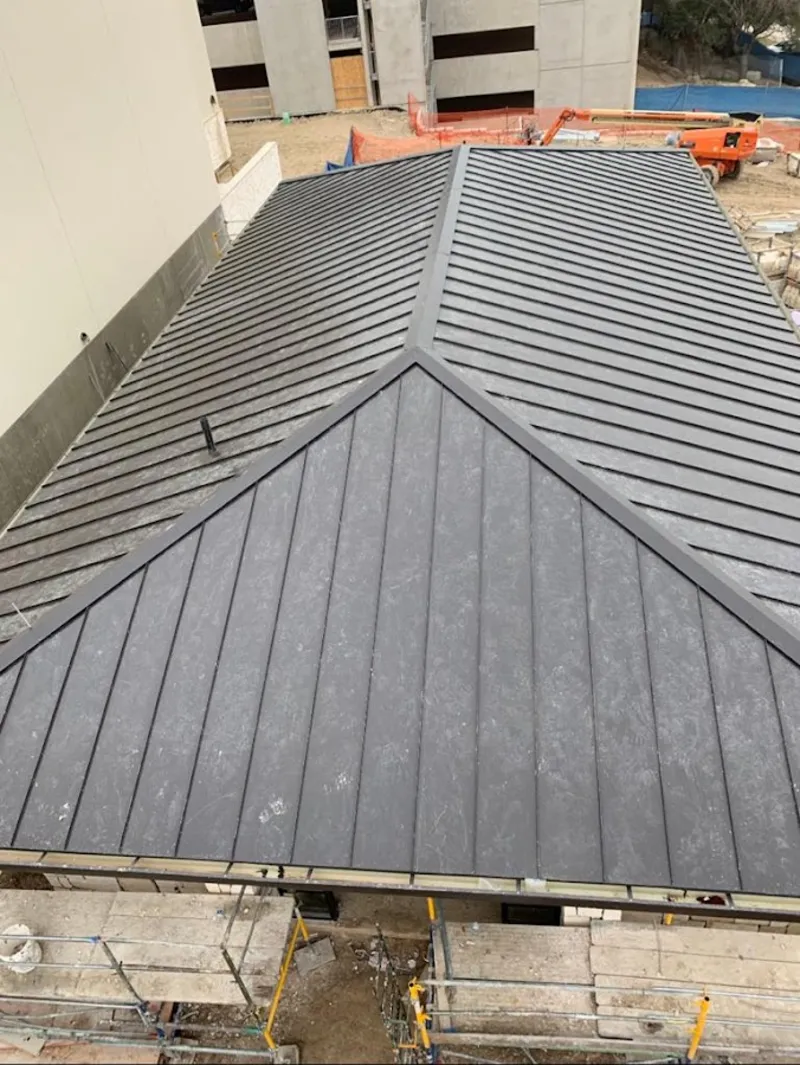 Commercial metal roof construction with crane equipment in Mount Carmel